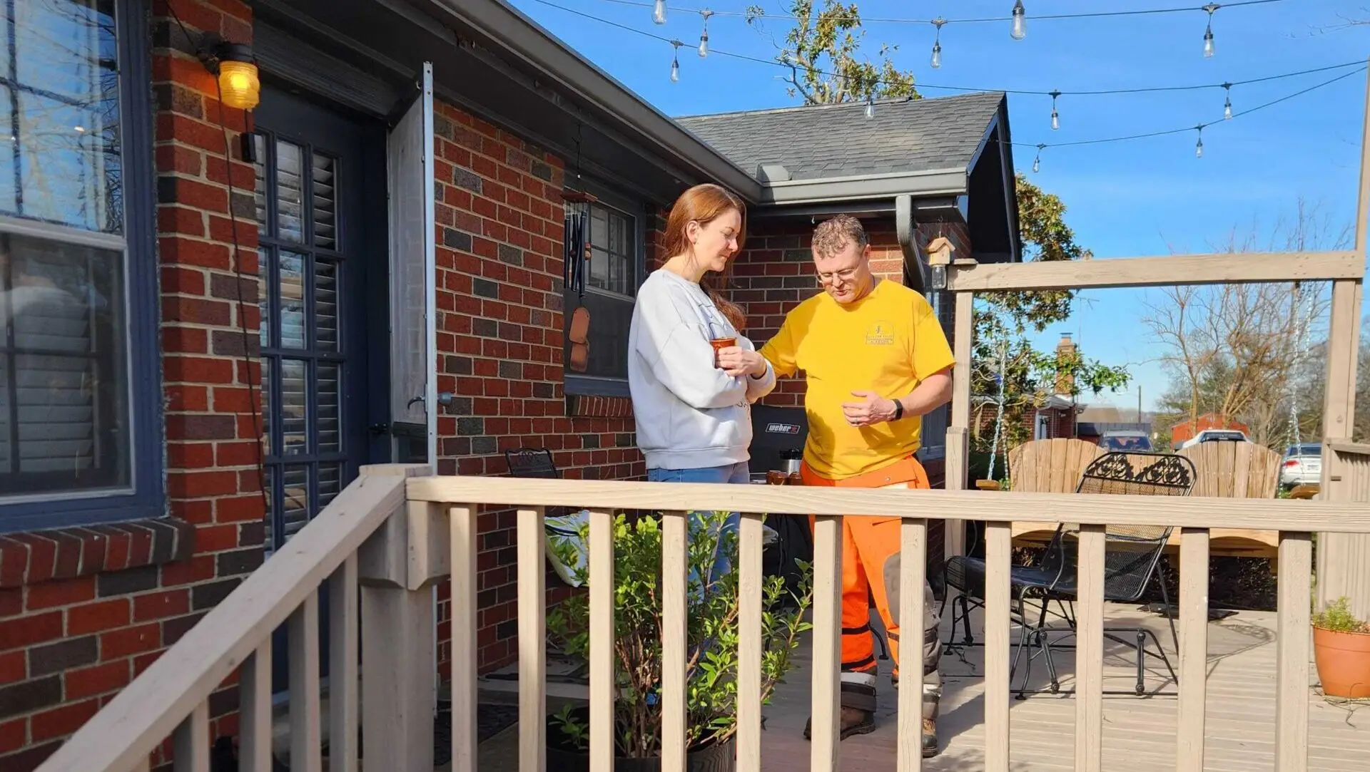 Alabama Baptist Disaster Relief volunteer prays with resident affected by tornado damage