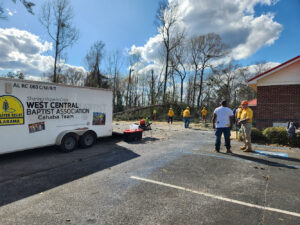 The disaster relief team from West Central Baptist Association works to clean up storm damage in Plantersville, which was hit by a tornado