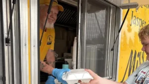 Stories 2 Disaster Relief volunteer offers a smile and a hot meal to a Kerr County resident following the July 4 floods.