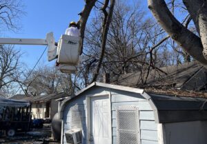 An Alabama Baptist Disaster Relief volunteer works to clear a fallen tree limb at a home in Greenville, Mississippi.